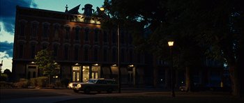 Movie still from “No Country for Old Men” (2007), directed by Joel Coen – A car parked on the side of the street at night; Extreme Wide shot, Low angle