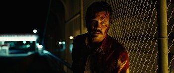 Movie still from “No Country for Old Men” (2007), directed by Joel Coen – A man with blood all over his face and chest; Close Up shot, Low angle