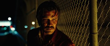 Movie still from “No Country for Old Men” (2007), directed by Joel Coen – A man with blood all over his face; Close Up shot, Low angle