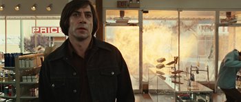 Movie still from “No Country for Old Men” (2007), directed by Joel Coen – Javier bardem in the movie no country for old men; Medium shot, Low angle