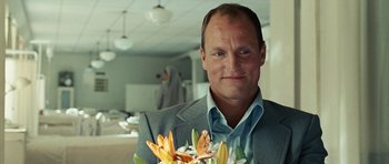 Movie still from “No Country for Old Men” (2007), directed by Joel Coen – A person holding a bouquet of flowers; Close Up shot, Over the shoulder angle