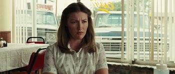 Movie still from “No Country for Old Men” (2007), directed by Joel Coen – A person sitting in front of a window; Close Up shot, Over the shoulder angle