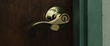 Movie still from “No Country for Old Men” (2007), directed by Joel Coen – A door handle with a key hole; Extreme Close Up shot, High angle