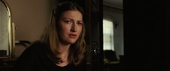 Movie still from “No Country for Old Men” (2007), directed by Joel Coen – A woman with long blonde hair is looking at the camera; Close Up shot, Over the shoulder angle