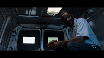 Movie still from “No Good Deed” (2014), directed by Sam Miller – A man sitting in the back of a van; Medium shot, Low angle