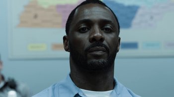 Movie still from “No Good Deed” (2014), directed by Sam Miller – A person wearing a blue shirt; Close Up shot, Low angle