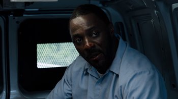 Movie still from “No Good Deed” (2014), directed by Sam Miller – A man sitting in the back of a vehicle; Close Up shot, Over the shoulder angle