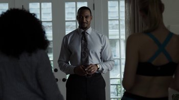 Movie still from “No Good Deed” (2014), directed by Sam Miller – A man standing in front of some people; Medium shot, Over the shoulder angle