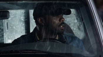 Movie still from “No Good Deed” (2014), directed by Sam Miller – A man sitting in the driver's seat of a car; Close Up shot, Over the shoulder angle