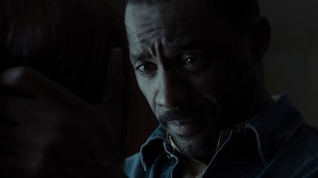 Movie still from “No Good Deed” (2014), directed by Sam Miller – A man's face in the dark; Close Up shot, Over the shoulder angle