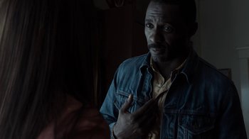 Movie still from “No Good Deed” (2014), directed by Sam Miller – A man in a yellow shirt and a blue jean jacket; Close Up shot, Over the shoulder angle