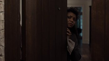 Movie still from “No Good Deed” (2014), directed by Sam Miller – A woman leaning against a wooden door; Medium shot, Low angle