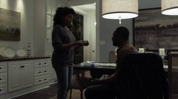 Movie still from “No Good Deed” (2014), directed by Sam Miller – Two people sitting at a table in a living room; Medium shot, Over the shoulder angle