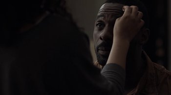 Movie still from “No Good Deed” (2014), directed by Sam Miller – A man looking into a mirror while holding his hair; Close Up shot, Over the shoulder angle