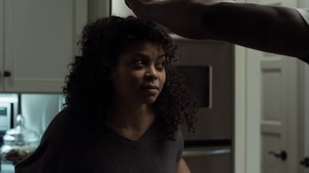 Movie still from “No Good Deed” (2014), directed by Sam Miller – A woman with curly black hair standing in a kitchen; Close Up shot, Over the shoulder angle