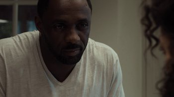 Movie still from “No Good Deed” (2014), directed by Sam Miller – A person wearing a white t - shirt; Close Up shot, High angle