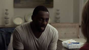 Movie still from “No Good Deed” (2014), directed by Sam Miller – A man sitting at a dining room table; Close Up shot, Over the shoulder angle