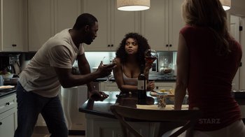 Movie still from “No Good Deed” (2014), directed by Sam Miller – A group of people standing around a kitchen counter; Medium shot, Over the shoulder angle