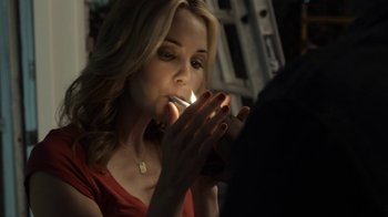 Movie still from “No Good Deed” (2014), directed by Sam Miller – A beautiful woman lighting a cigarette in a dark room; Close Up shot, Over the shoulder angle
