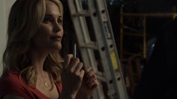 Movie still from “No Good Deed” (2014), directed by Sam Miller – A woman holding a pen in her hands; Close Up shot, Over the shoulder angle