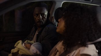 Movie still from “No Good Deed” (2014), directed by Sam Miller – A man and a woman sitting in a car with a baby; Close Up shot, Over the shoulder angle