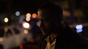 Movie still from “No Good Deed” (2014), directed by Sam Miller – A person wearing a suit and tie; Close Up shot, Over the shoulder angle