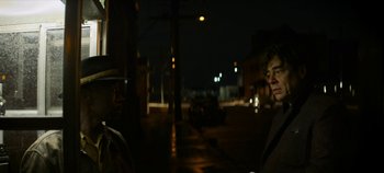 Movie still from “No Sudden Move” (2021), directed by Steven Soderbergh – Two men standing on the side of the road at night; Medium shot, Over the shoulder angle