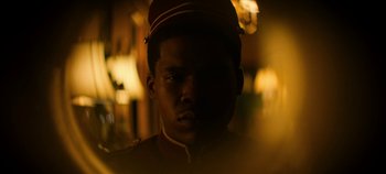 Movie still from “No Sudden Move” (2021), directed by Steven Soderbergh – A person wearing a uniform; Close Up shot, Low angle
