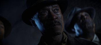 Movie still from “No Sudden Move” (2021), directed by Steven Soderbergh – A person wearing a hat; Close Up shot, Low angle