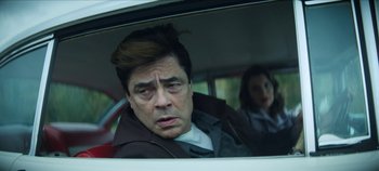 Movie still from “No Sudden Move” (2021), directed by Steven Soderbergh – A man and a woman in the back seat of a car; Close Up shot, Low angle