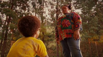 Movie still from “Norbit” (2007), directed by Brian Robbins – Two young children standing next to each other in a wooded area; Wide shot, Over the shoulder angle