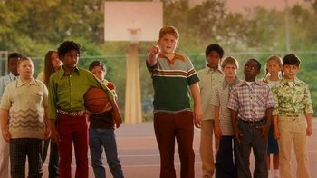 Movie still from “Norbit” (2007), directed by Brian Robbins – A group of young people standing next to each other on a basketball court; Medium shot, Low angle