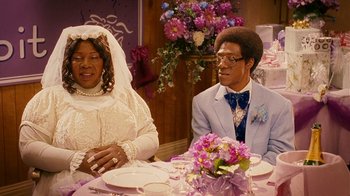 Movie still from “Norbit” (2007), directed by Brian Robbins – A man and a woman sitting at a dinner table; Medium shot, Over the shoulder angle