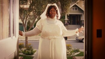 Movie still from “Norbit” (2007), directed by Brian Robbins – A woman in a wedding dress standing in front of a house; Medium shot, Over the shoulder angle
