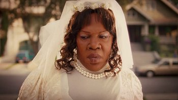 Movie still from “Norbit” (2007), directed by Brian Robbins – A woman wearing a wedding dress and veil; Close Up shot, Over the shoulder angle