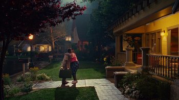 Movie still from “Norbit” (2007), directed by Brian Robbins – A woman hugging another woman while holding a suitcase; Extreme Wide shot, High angle