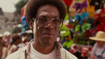 Movie still from “Norbit” (2007), directed by Brian Robbins – A person wearing glasses and a plaid shirt; Close Up shot, High angle