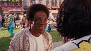 Movie still from “Norbit” (2007), directed by Brian Robbins – A young man with glasses is talking to a woman; Close Up shot, Over the shoulder angle