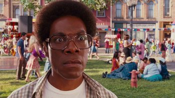 Movie still from “Norbit” (2007), directed by Brian Robbins – A man with a surprised look on his face in a park; Close Up shot, High angle