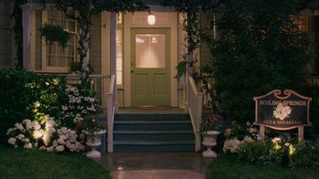 Movie still from “Norbit” (2007), directed by Brian Robbins – A green door and steps leading up to a house; Wide shot, High angle