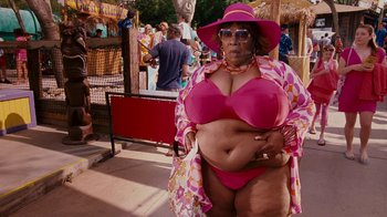 Movie still from “Norbit” (2007), directed by Brian Robbins – A woman in a pink bathing suit and a pink hat; Medium shot, Low angle