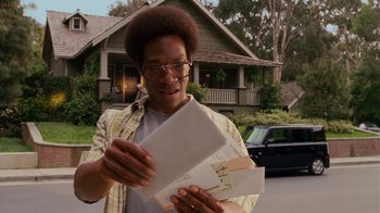 Movie still from “Norbit” (2007), directed by Brian Robbins – A man holding a bunch of mail in his hands; Medium shot, Low angle