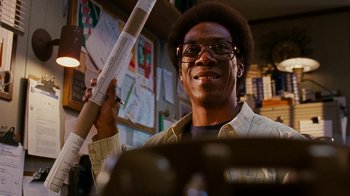 Movie still from “Norbit” (2007), directed by Brian Robbins – A man is holding a drum stick in his hand; Close Up shot, Low angle