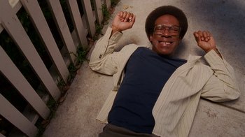 Movie still from “Norbit” (2007), directed by Brian Robbins – A man laying on the ground with his hands up; Medium shot, Overhead angle