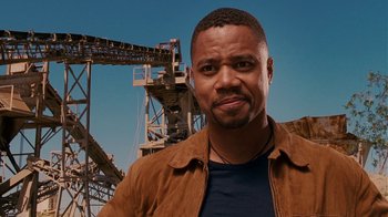 Movie still from “Norbit” (2007), directed by Brian Robbins – A man standing in front of an iron ore mine; Close Up shot, Low angle