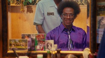 Movie still from “Norbit” (2007), directed by Brian Robbins – A man sitting in front of a mirror in front of another man; Close Up shot, Over the shoulder angle
