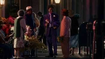 Movie still from “Norbit” (2007), directed by Brian Robbins – A group of people standing on a sidewalk at night; Wide shot, Over the shoulder angle
