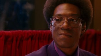Movie still from “Norbit” (2007), directed by Brian Robbins – A person wearing glasses and a purple shirt; Close Up shot, Low angle