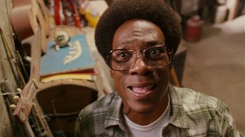 Movie still from “Norbit” (2007), directed by Brian Robbins – A person wearing glasses and a plaid shirt; Close Up shot, High angle