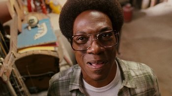 Movie still from “Norbit” (2007), directed by Brian Robbins – A person wearing glasses and a plaid shirt; Close Up shot, Low angle